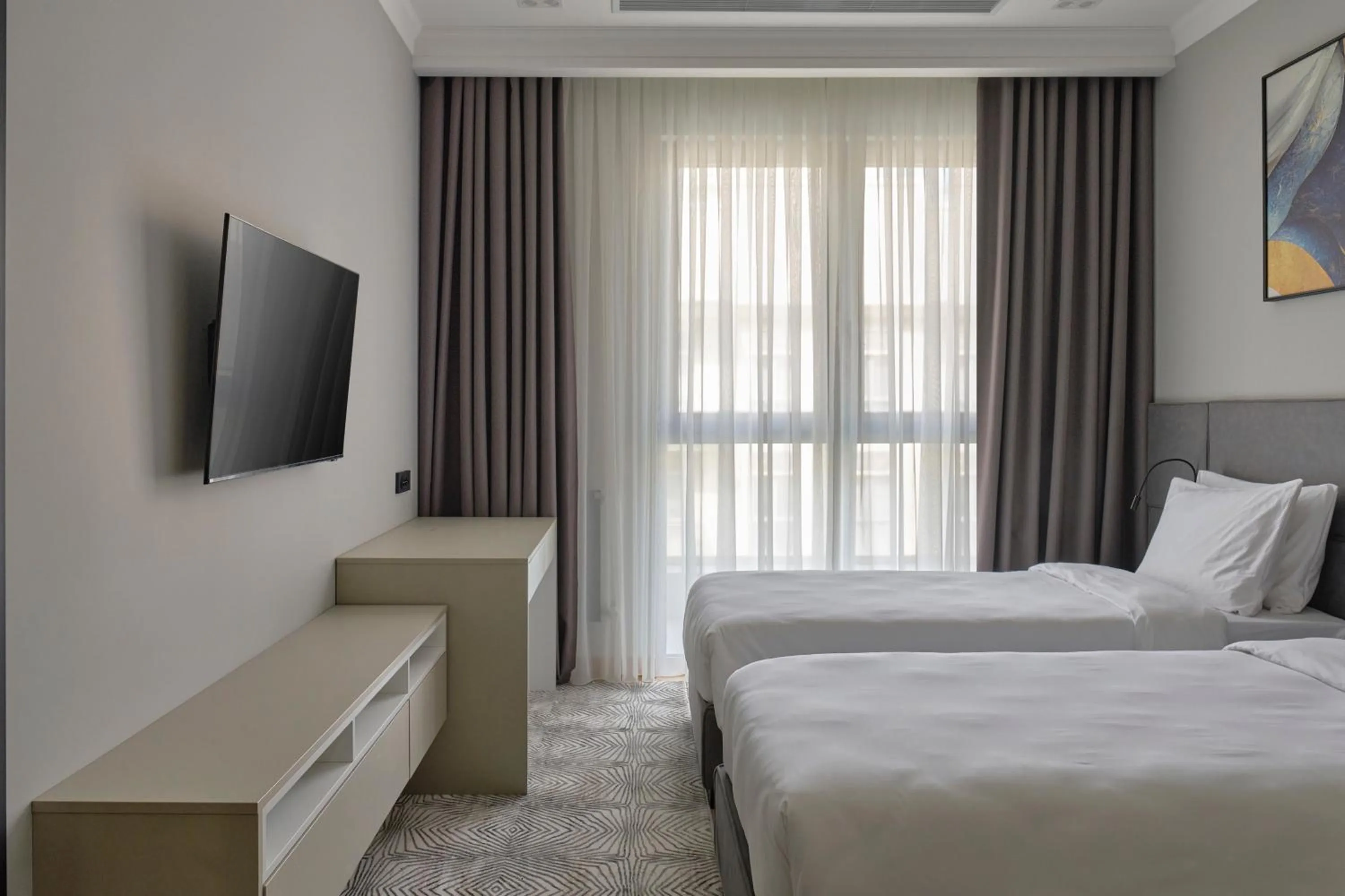 Bed in STYLO Residences & Suites