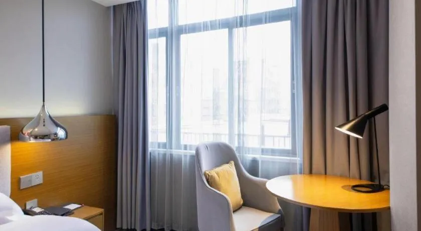 Bed in Borrman Hotel Zhanjiang Wuchuan Jinsha Plaza