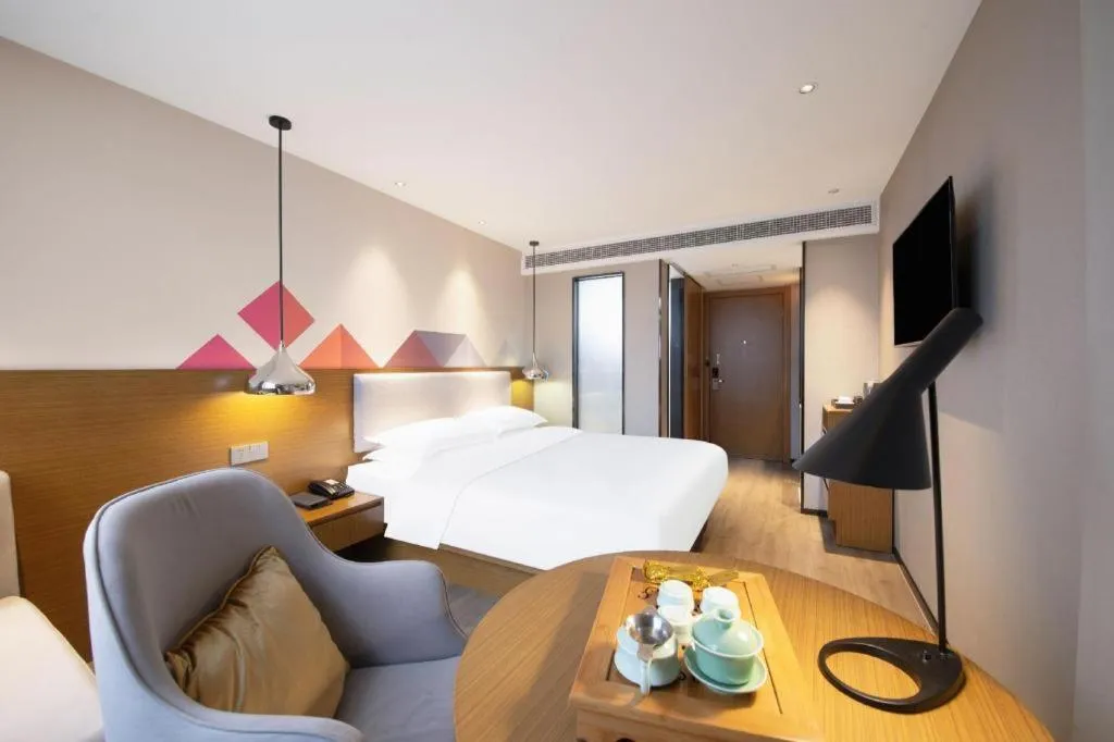 Bed in Borrman Hotel Zhanjiang Wuchuan Jinsha Plaza