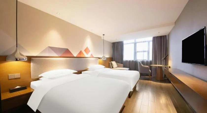 Bed in Borrman Hotel Zhanjiang Wuchuan Jinsha Plaza