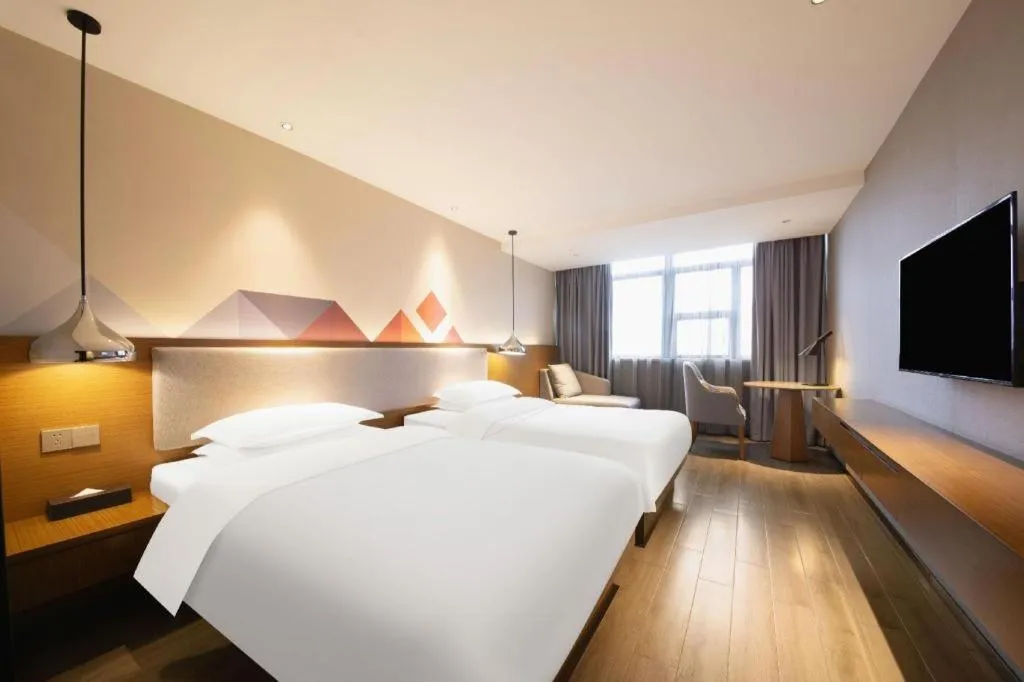Bed in Borrman Hotel Zhanjiang Wuchuan Jinsha Plaza