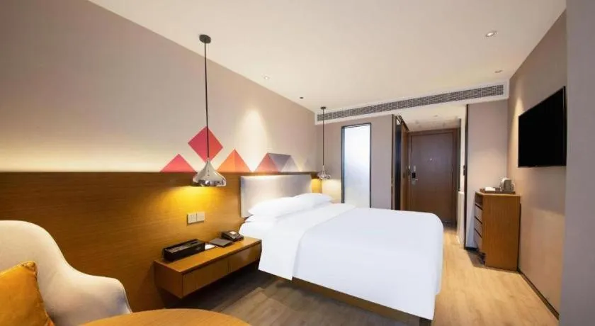 Bed in Borrman Hotel Zhanjiang Wuchuan Jinsha Plaza