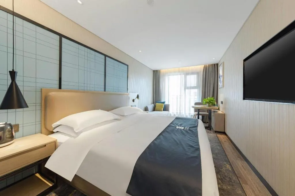Bed in Echarm Hotel Wuhan Huangpi Xiangyang Avenue