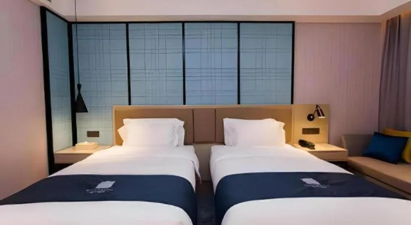 Bed in Echarm Hotel Tai'an Taishan Tianwai Village Hongmen