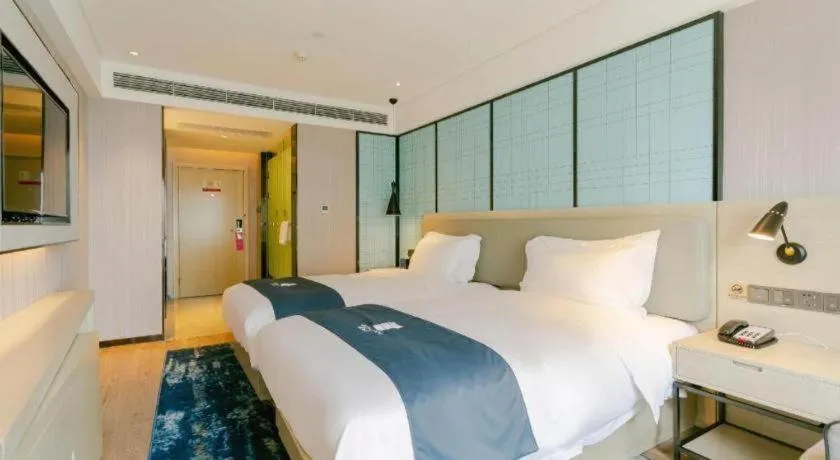 Bed in Echarm Hotel Kunming High-speed Railway South Station Chunrong Street Metro Station