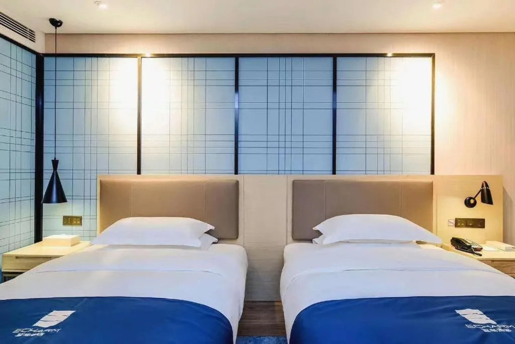 Bed in Echarm Hotel Kunming High-speed Railway South Station Chunrong Street Metro Station