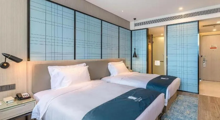 Bed in Echarm Hotel Kunming High-speed Railway South Station Chunrong Street Metro Station