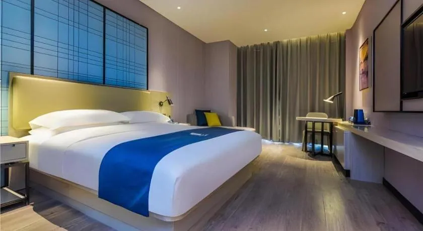 Bed in Echarm Hotel Guiyang Qianling Mountain