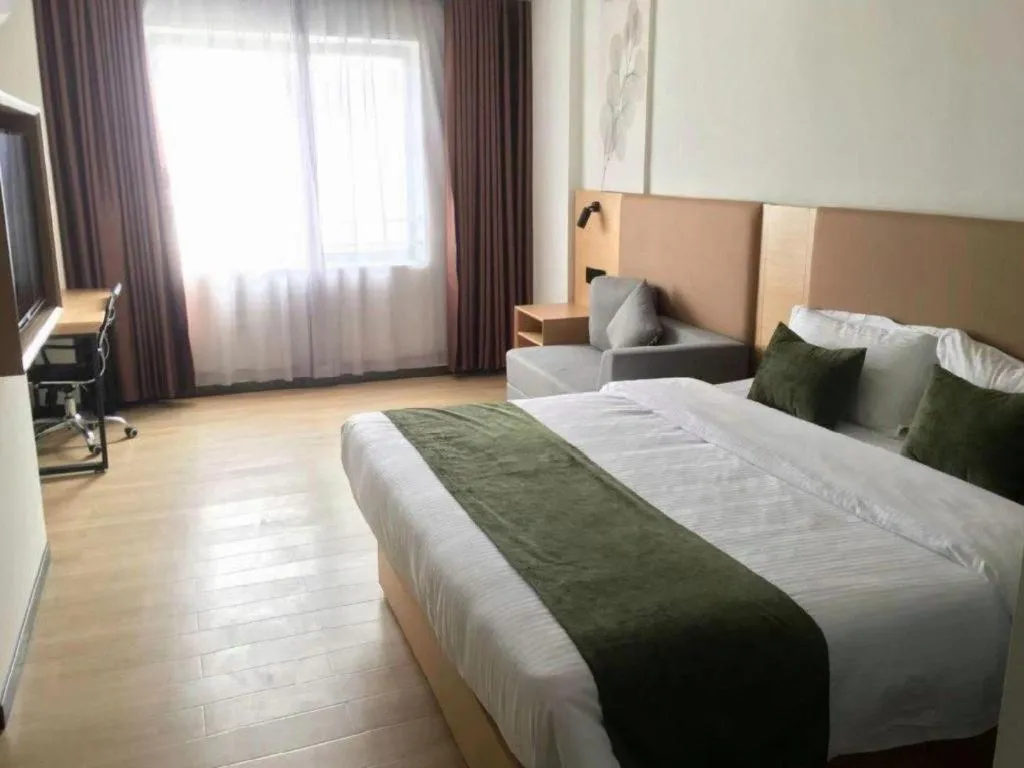 Bed in Green Tree Inn Guangxi Wuzhou 2nd Xinxing Road Liangguang Market