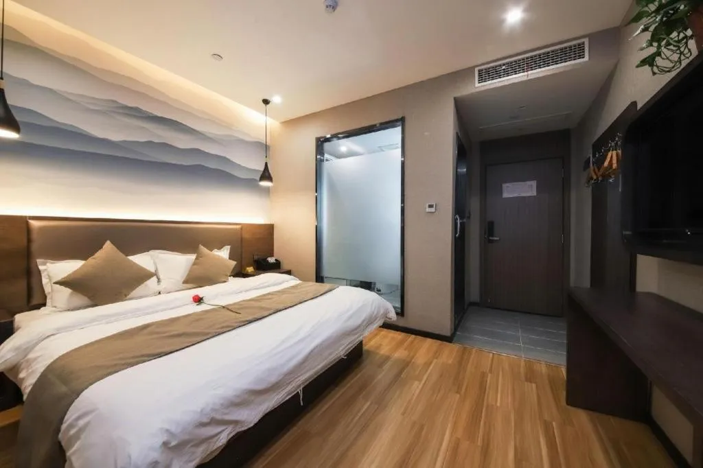 Bed in Shell Hotel Zhengzhou East High-Speed Railway Station Zhengdong Commerical Center