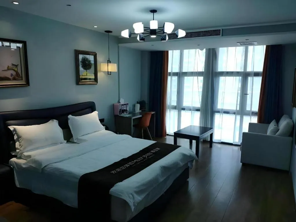 Bed in Shell Hotel Zhengzhou East High-Speed Railway Station Zhengdong Commerical Center