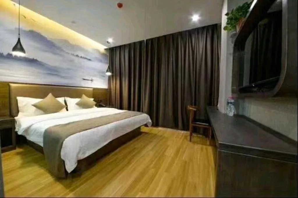 Bed in Shell Hotel Zhengzhou East High-Speed Railway Station Zhengdong Commerical Center