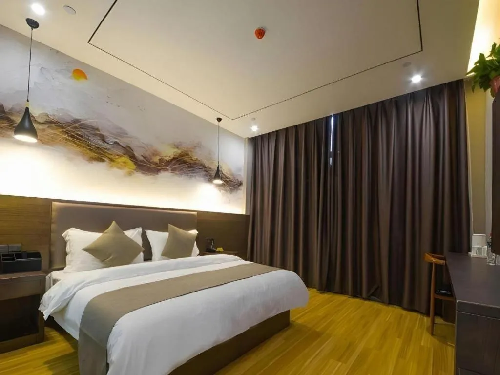 Bed in Shell Hotel Zhengzhou East High-Speed Railway Station Zhengdong Commerical Center