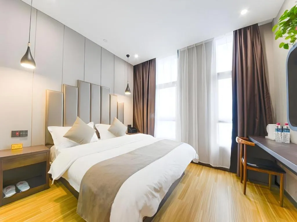 Bed in Shell Hotel Zhengzhou East High-Speed Railway Station Zhengdong Commerical Center