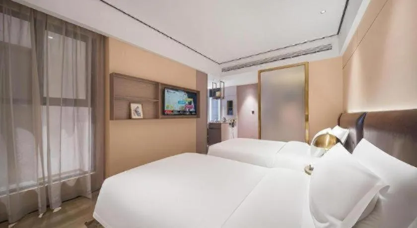 Bed in Premier City Comfort Hotel Quanzhou Wanda Plaza