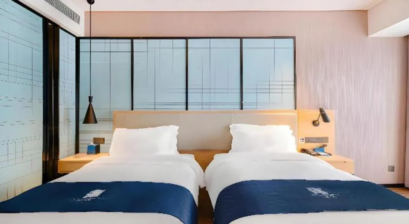 Bed in Echarm Hotel Suzhou Shengze Oriental Extile City