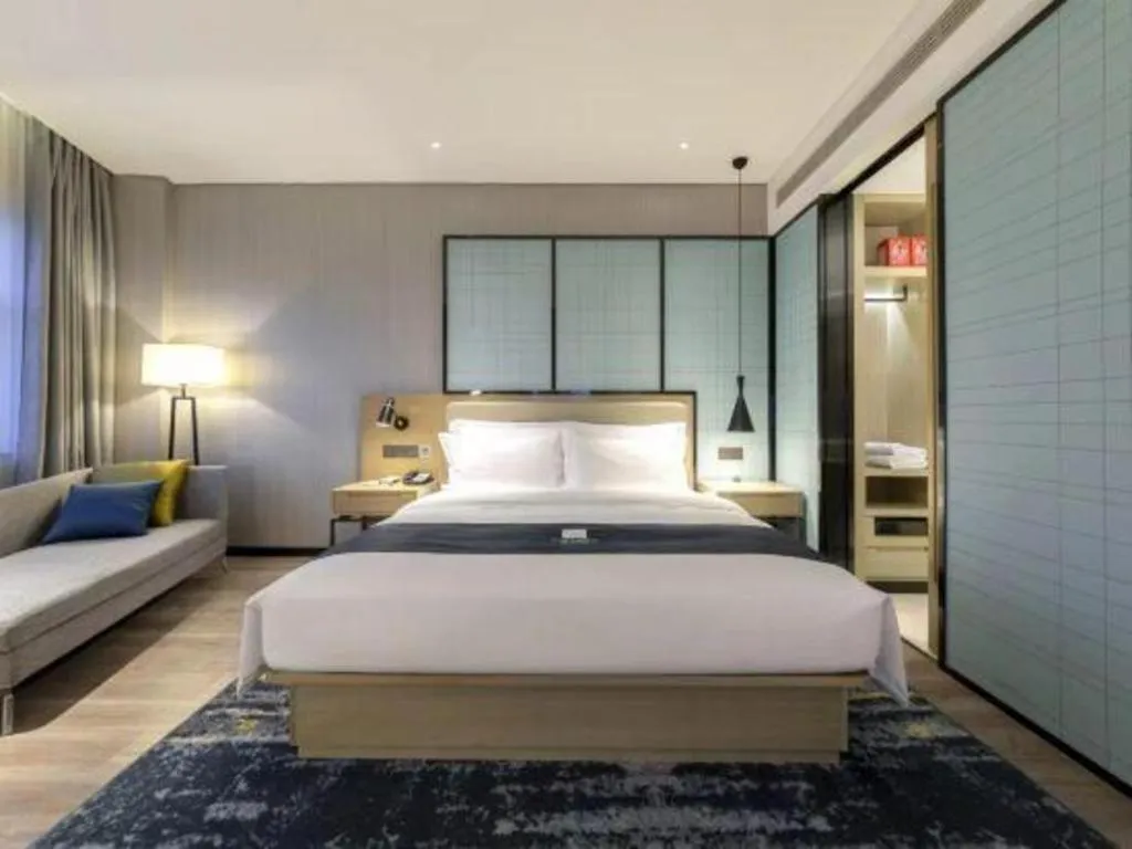 Bed in Echarm Hotel Suzhou Shengze Oriental Extile City