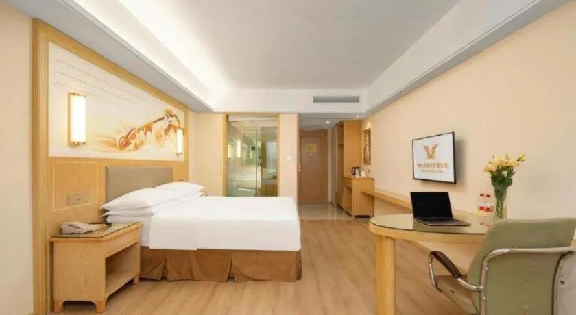 Bed in Vienna Hotel Chongqing Shizhu Stadium