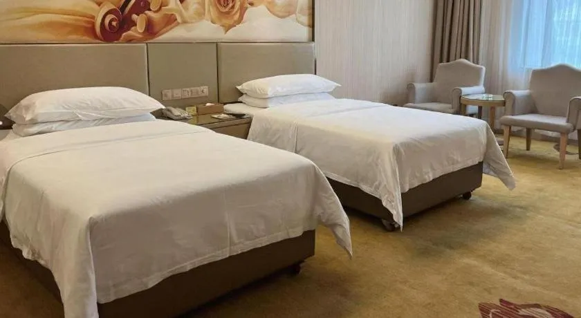 Bed in Vienna Hotel Guangdong Huidong Herung Pedestrian Street