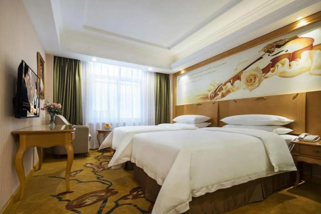 Bed in Vienna Hotel Guangdong Huidong Herung Pedestrian Street