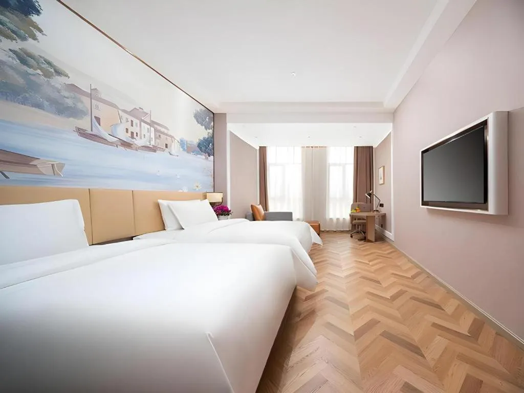 Bed in Vienna Hotel Lincang New Asia Pacific Times Square
