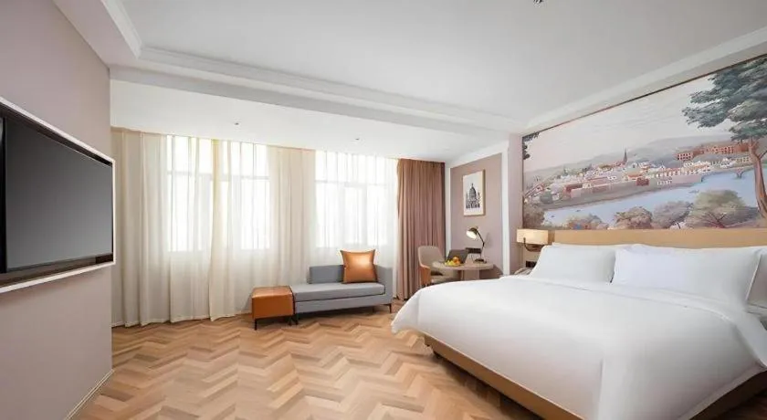 Bed in Vienna Hotel Lincang New Asia Pacific Times Square