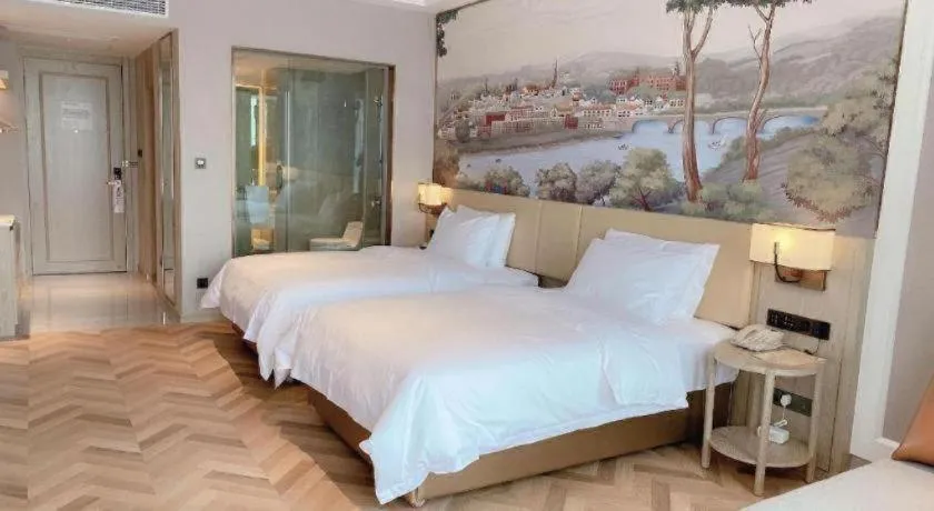 Bed in Vienna Hotel Lincang New Asia Pacific Times Square