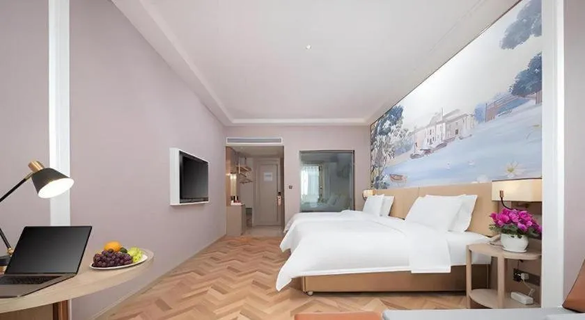 Bed in Vienna Hotel Lincang New Asia Pacific Times Square