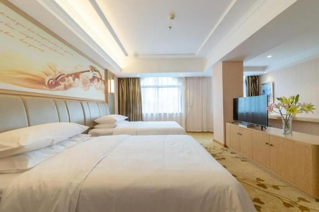 Bed in Vienna Hotel Guangxi Zhongshan Central Plaza West High-Speed Railway Station