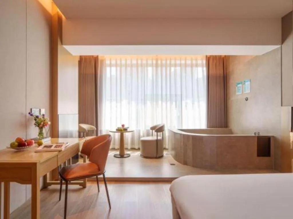 Bed in Vienna Hotel Yunnan Maitreya Huquan