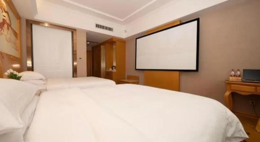Bed in Vienna Hotel Guangxi Fangcheng