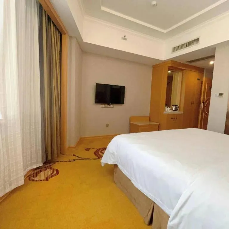 Bed in Vienna Hotel Guangxi Fangcheng
