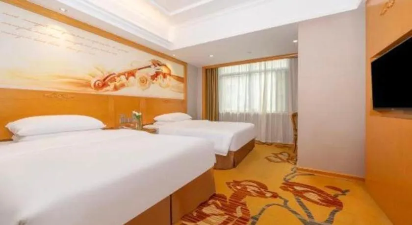 Bed in Vienna Hotel Guangxi Fangcheng
