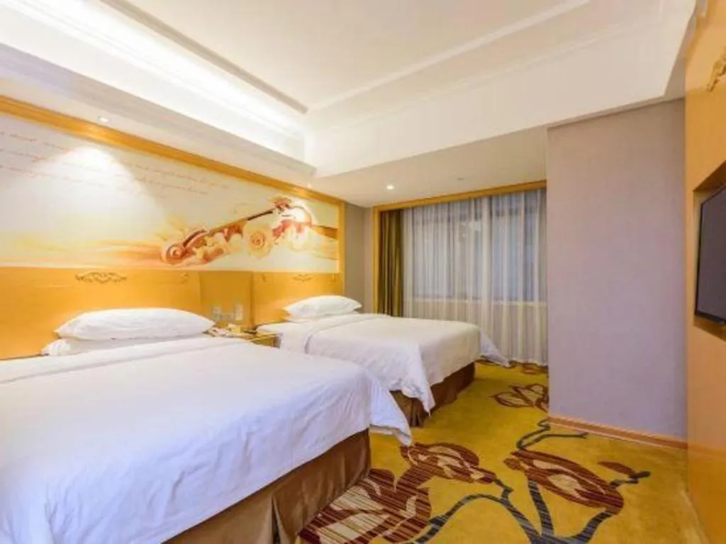 Bed in Vienna Hotel Guangxi Fangcheng