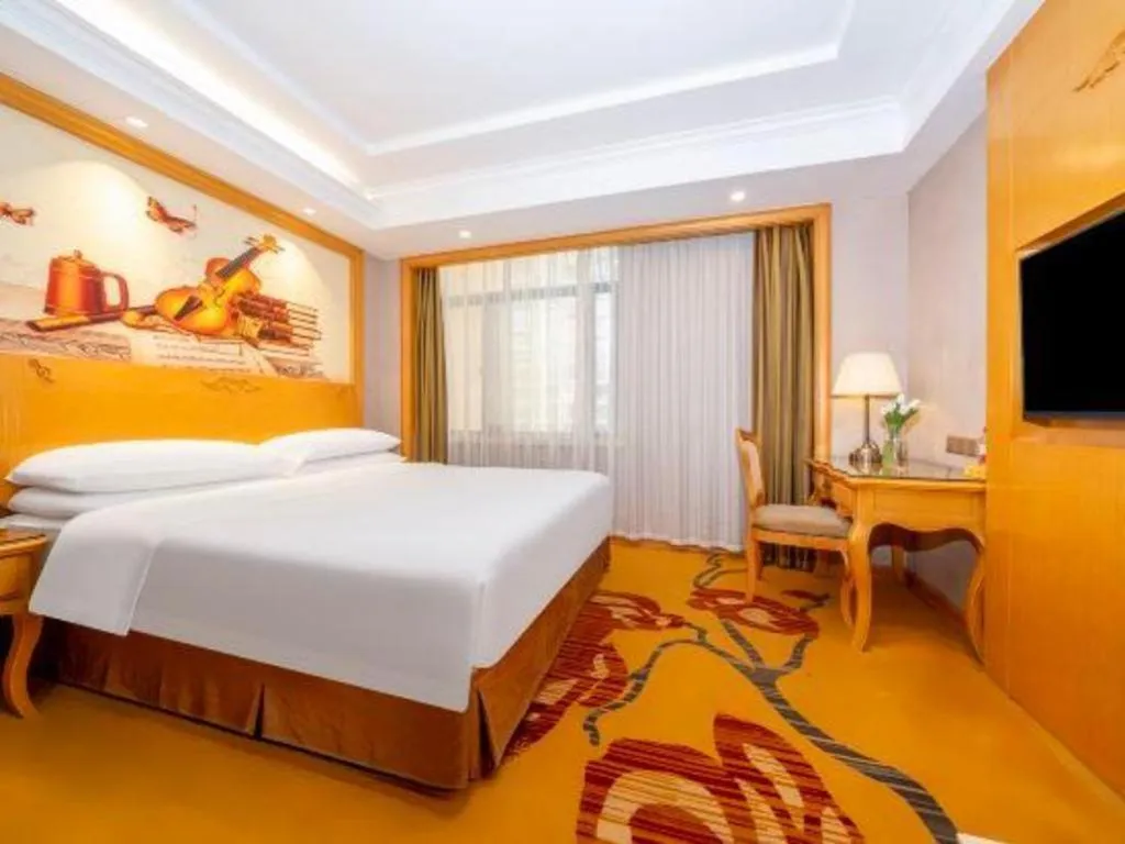 Bed in Vienna Hotel Guangxi Fangcheng