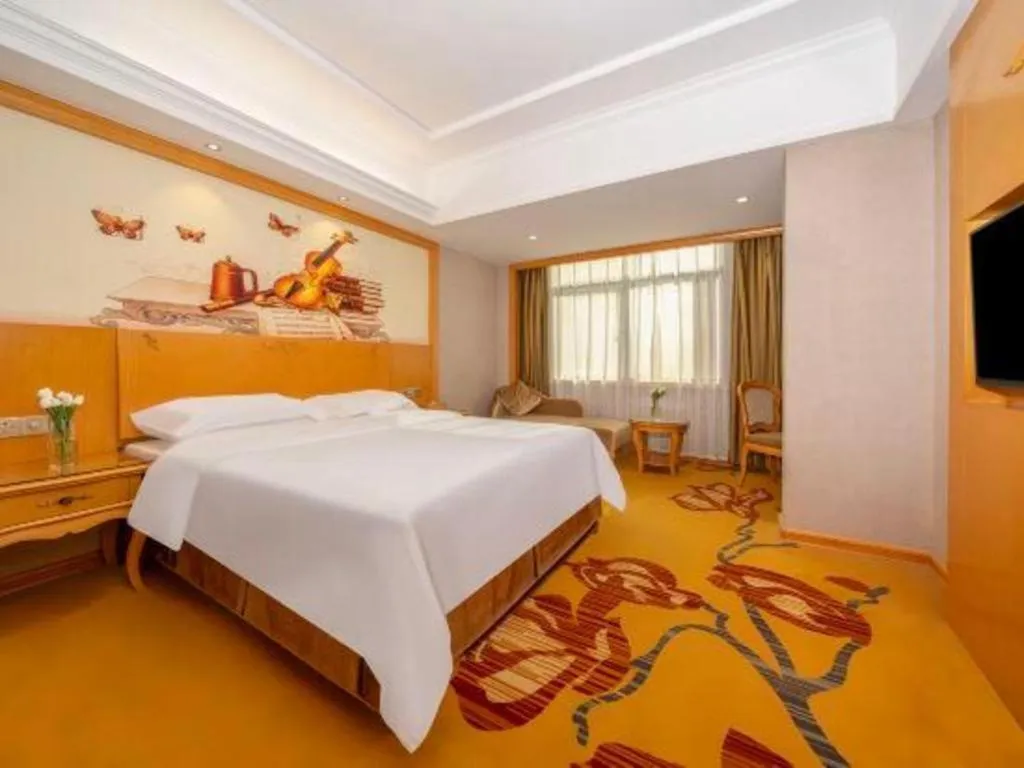 Bed in Vienna Hotel Guangxi Fangcheng