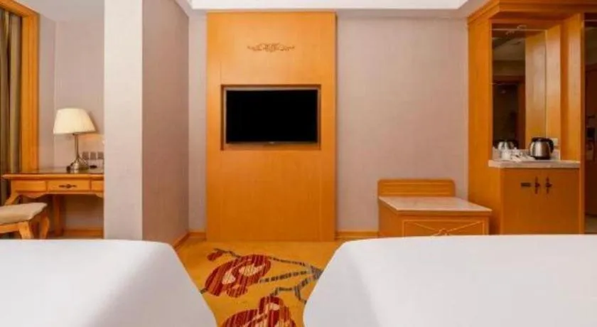 Bed in Vienna Hotel Guangxi Fangcheng