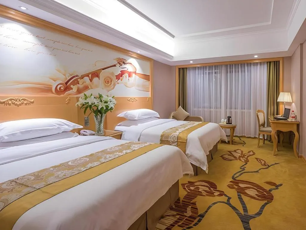 Bed in Vienna Hotel Guangxi Fangcheng