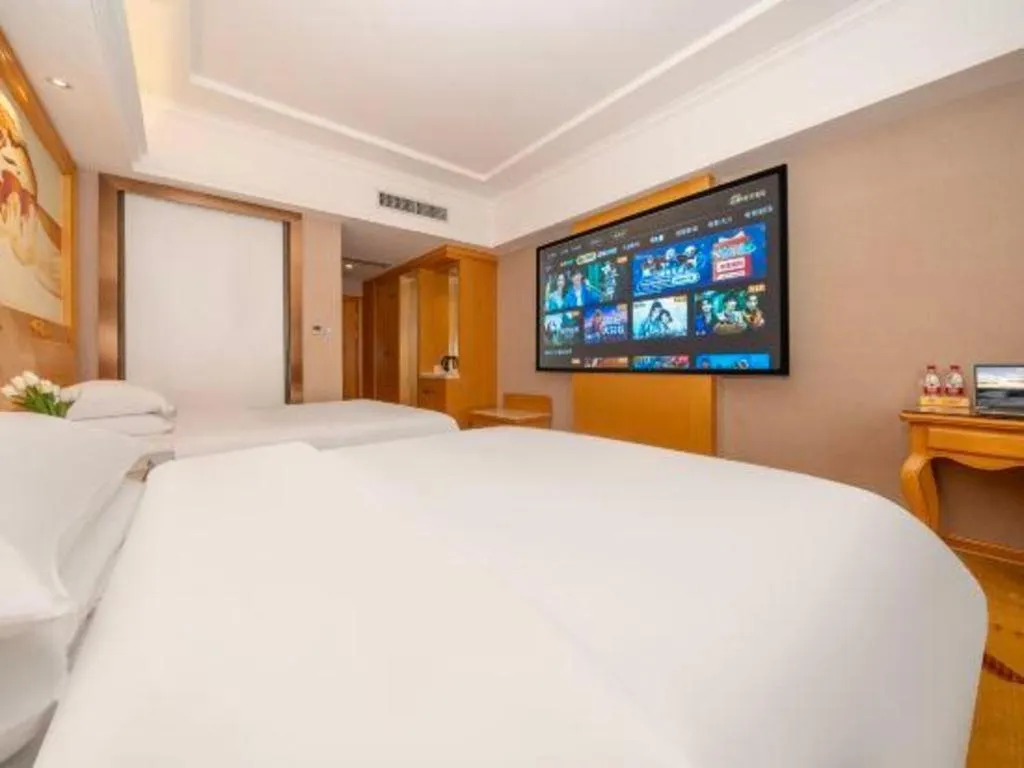 Bed in Vienna Hotel Guangxi Fangcheng