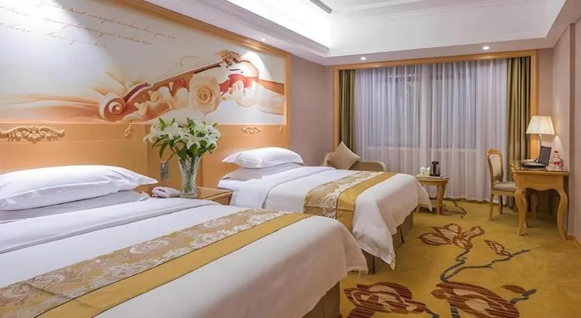 Bed in Vienna Hotel Guangxi Fangcheng