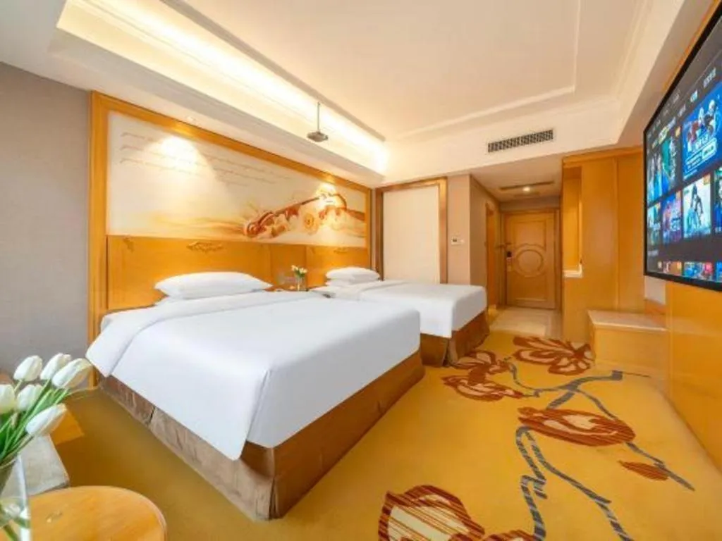 Bed in Vienna Hotel Guangxi Fangcheng