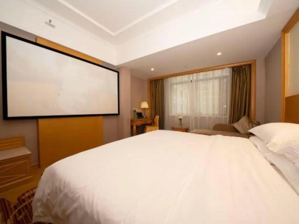Bed in Vienna Hotel Guangxi Fangcheng