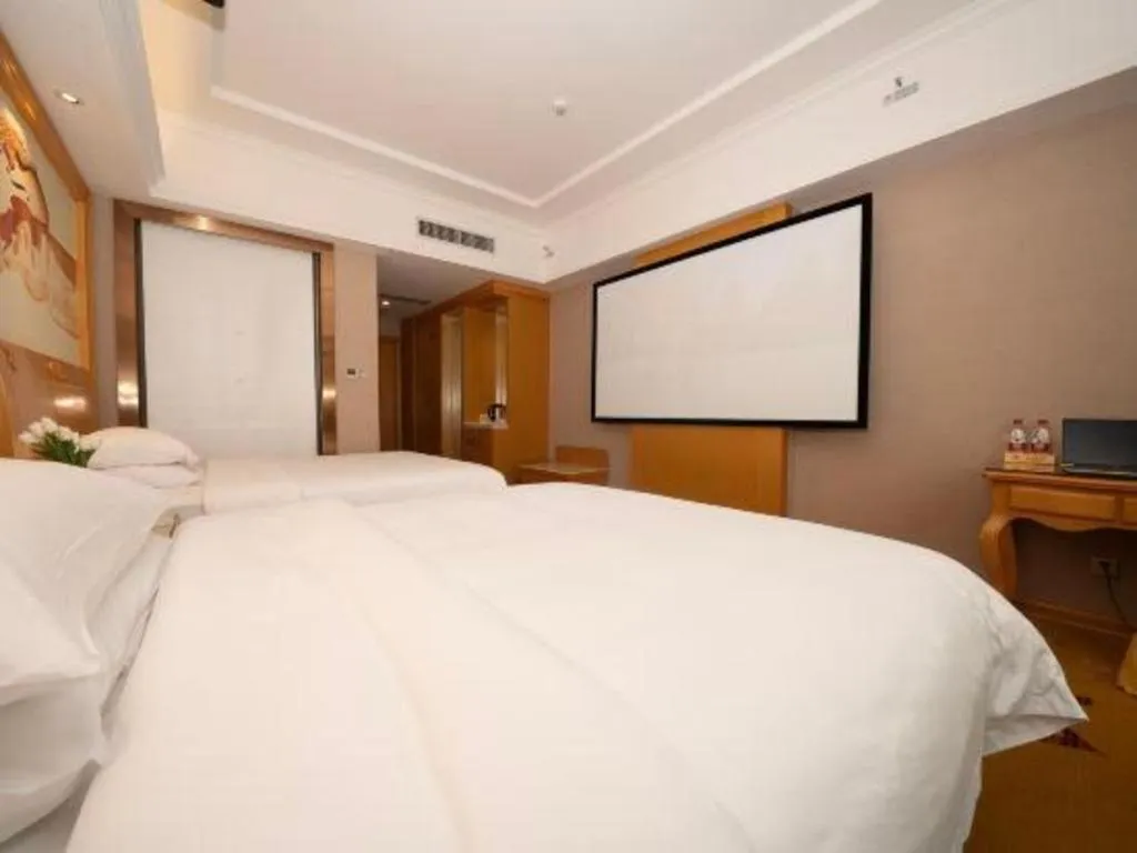 Bed in Vienna Hotel Guangxi Fangcheng