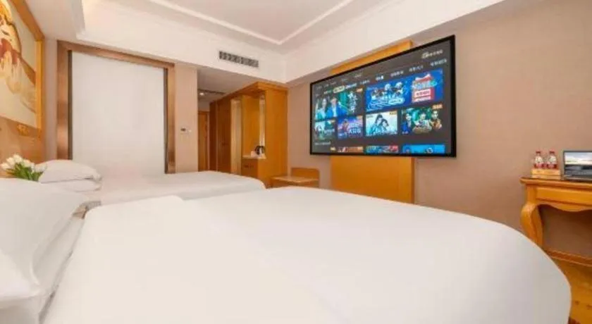 Bed in Vienna Hotel Guangxi Fangcheng