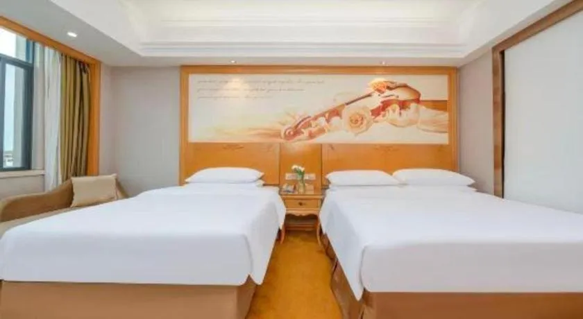 Bed in Vienna Hotel Guangxi Fangcheng