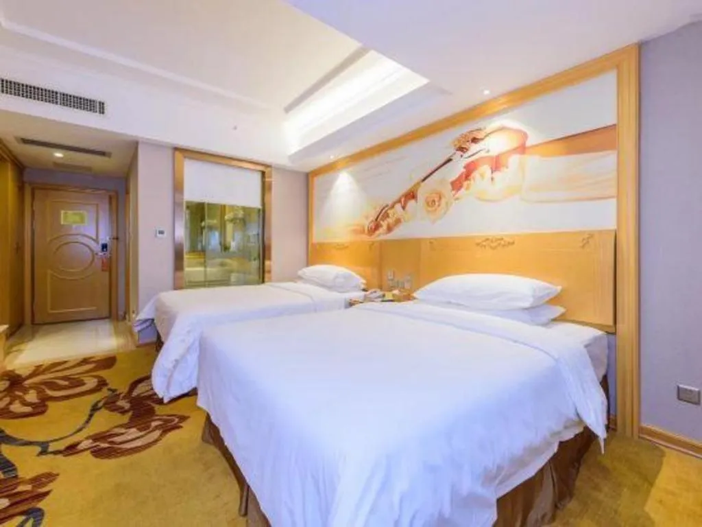 Bed in Vienna Hotel Guangxi Fangcheng