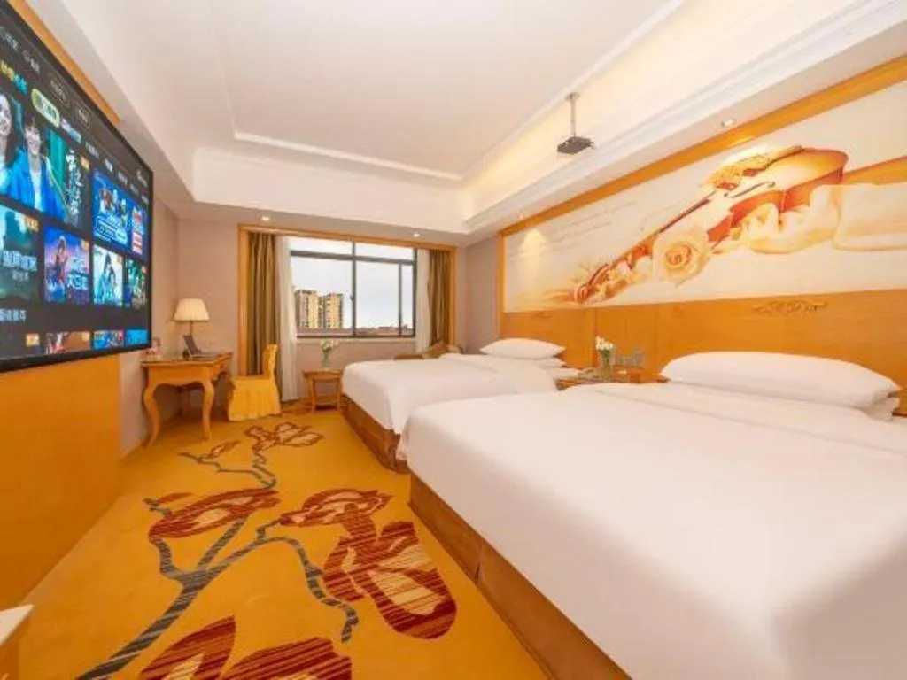 Bed in Vienna Hotel Guangxi Fangcheng