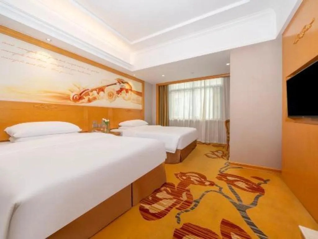 Bed in Vienna Hotel Guangxi Fangcheng