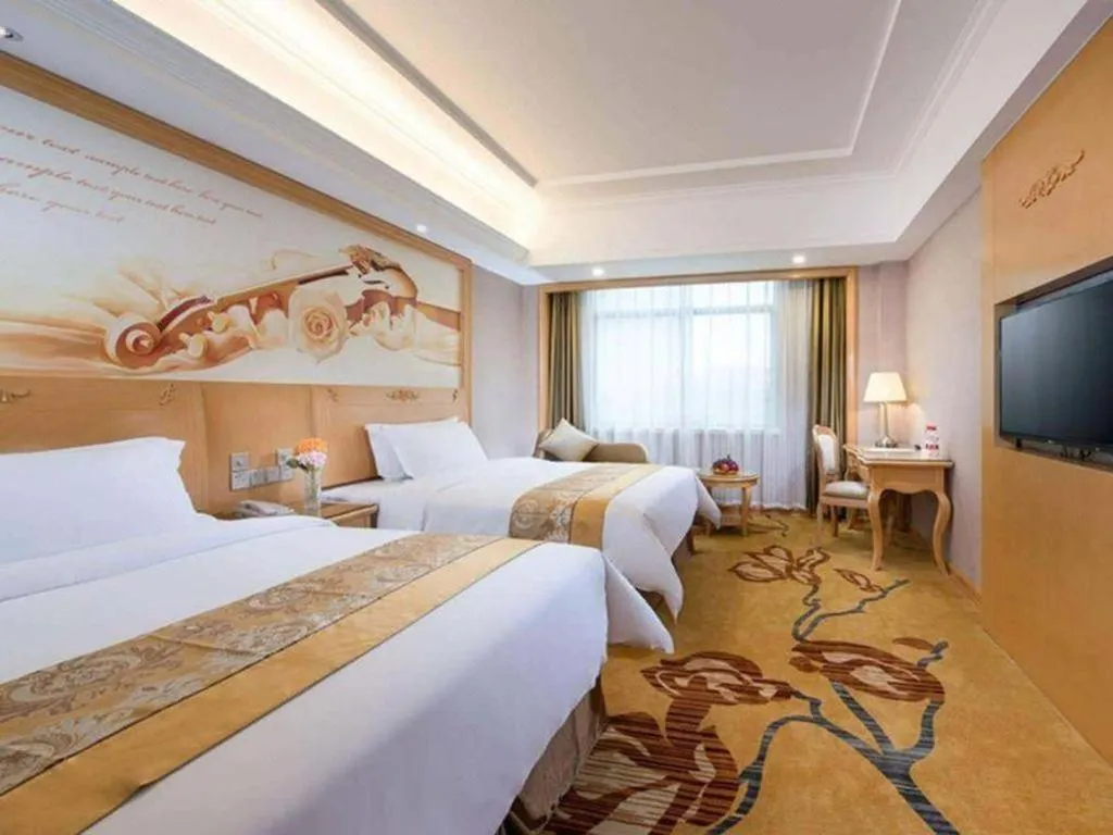 Bed in Vienna Hotel Guangxi Fangcheng