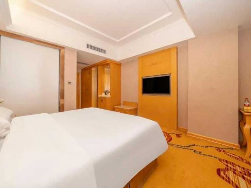 Bed in Vienna Hotel Guangxi Fangcheng